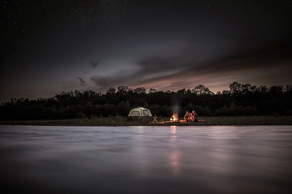 Photograph Fedele Studio Landscape Of Family Sitting Around Campfire By River on One Eyeland