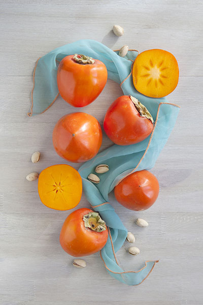 Photograph Ann Cutting Persimmons on One Eyeland