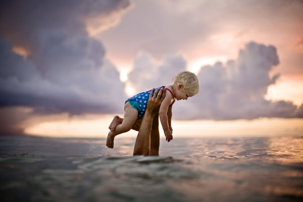 Photograph Jim Erickson Baby Held Up Out Of The Water on One Eyeland