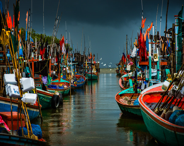 Photograph Nigel Hudson Coloured Fishing Boats Before A Storm Thailand on One Eyeland