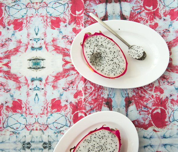 Photograph Ann Cutting Dragon Fruit On Fabric on One Eyeland