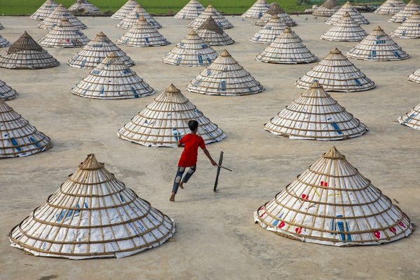Photograph Azim Khan Ronnie Playing In The Rice Mill on One Eyeland