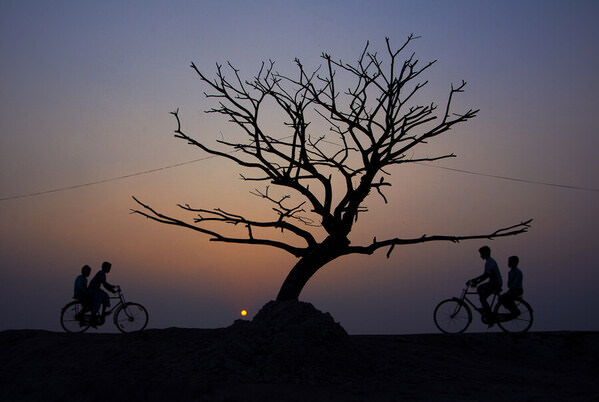 Photograph Chinmoy Biswas Afternoon Cyclists on One Eyeland