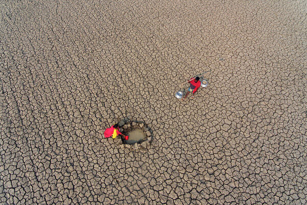 Photograph Sujon Adikary Collecting Water From Dried Out Riverbeds on One Eyeland