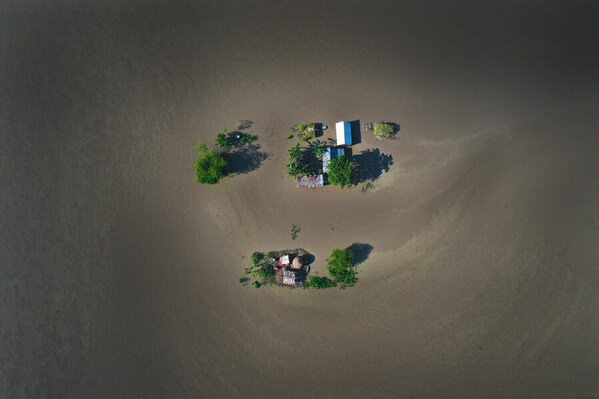 Photograph Sujon Adikary Living With The Floods On Floating Houses on One Eyeland