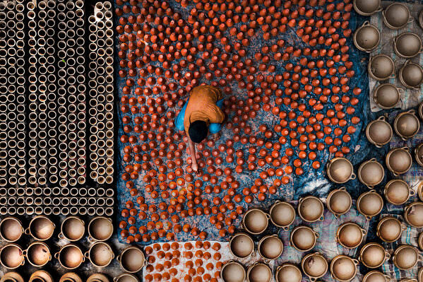 Photograph Sujon Adikary Drying Clay Curd Pots on One Eyeland
