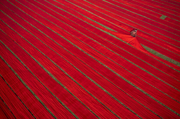 Photograph Azim Khan Ronnie Drying Red Clothes on One Eyeland