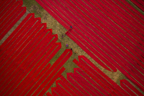 Photograph Azim Khan Ronnie Working On Red Clothes 02 on One Eyeland