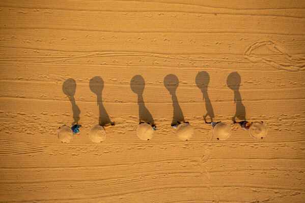 Photograph Azim Khan Ronnie Surreal Shadow In The Drying Rice Workers 02 on One Eyeland