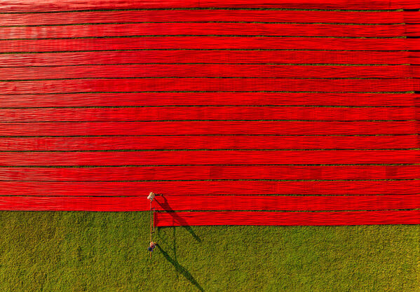 Photograph Azim Khan Ronnie Drying Red Cloths on One Eyeland