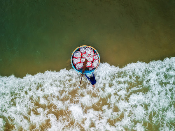 Photograph Quan Nguyen Carrying Fish To Shore on One Eyeland