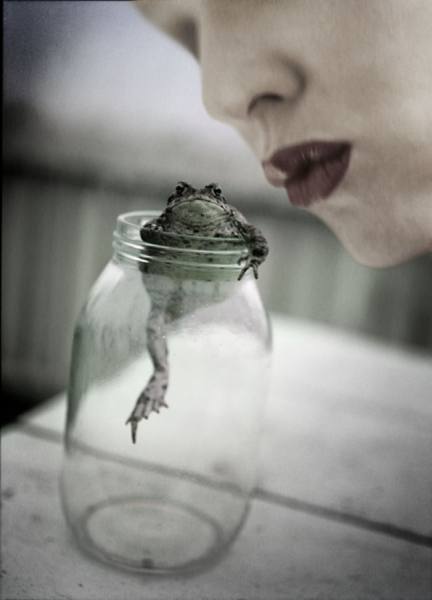 Photograph Jim Erickson A Woman Is Leaning To Kiss A Frog In A Bottle on One Eyeland