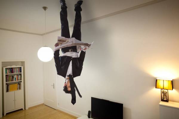 Photograph Ozkan Ozmen Upside Down At The Ceiling Reading Newspaper on One Eyeland