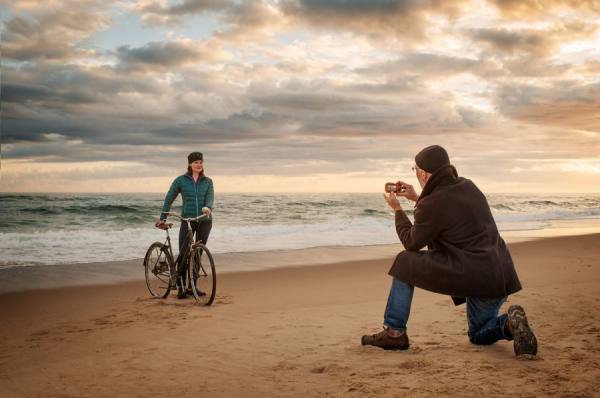 Photograph Robb Scharetg Boomer Couple Taking Pictures On The Beach on One Eyeland