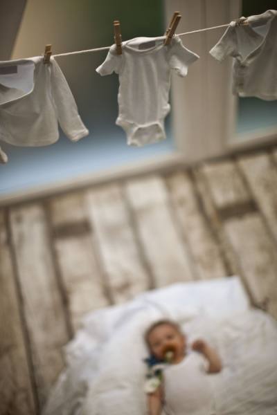 Photograph Jim Erickson Baby Looking At Clothes Hanging On Washline on One Eyeland