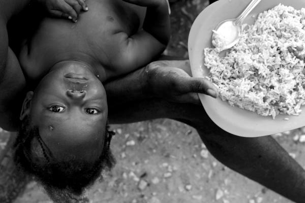 Photograph Wayne Chinnock Recovering Child In Lap At Lunch on One Eyeland